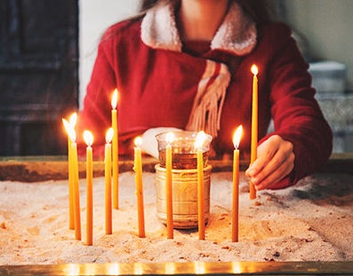 Woman lights candles