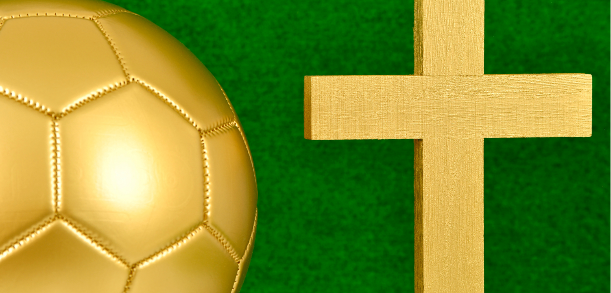 Golden ball and golden cross with a green background
