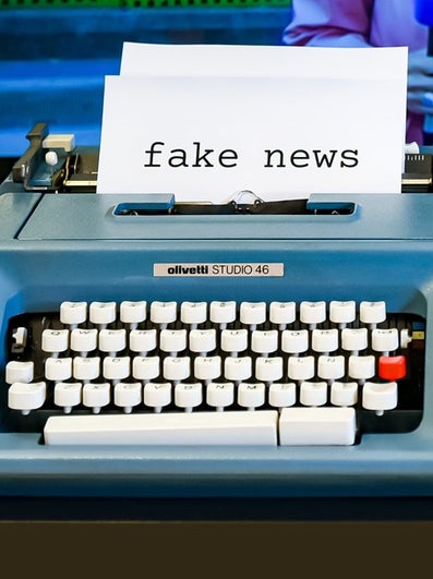 type writer with the words 'fake news'