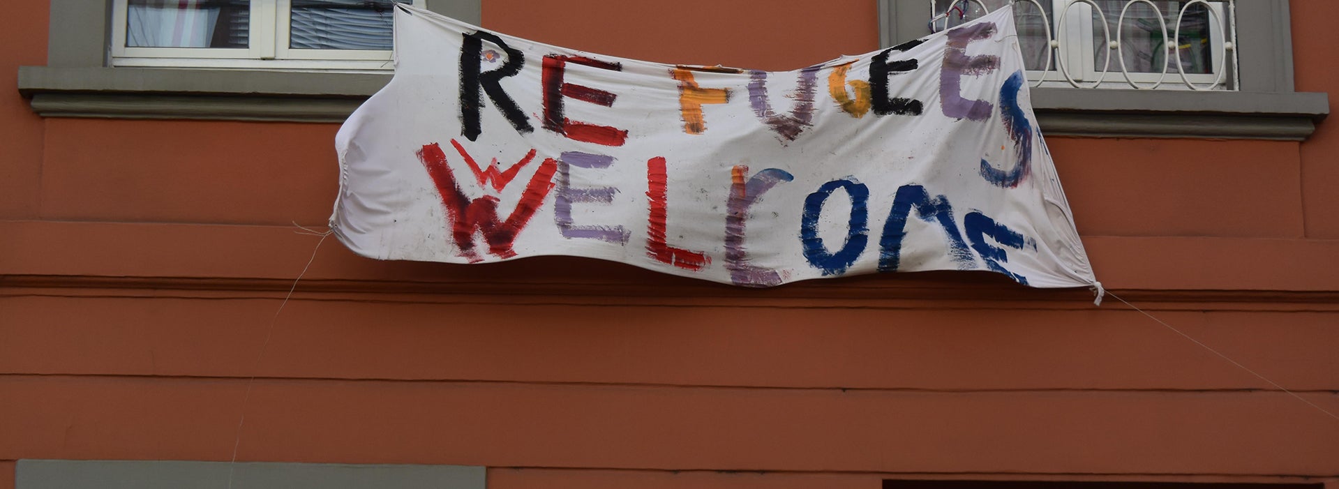 A banner with the text 'Refugees welcome'