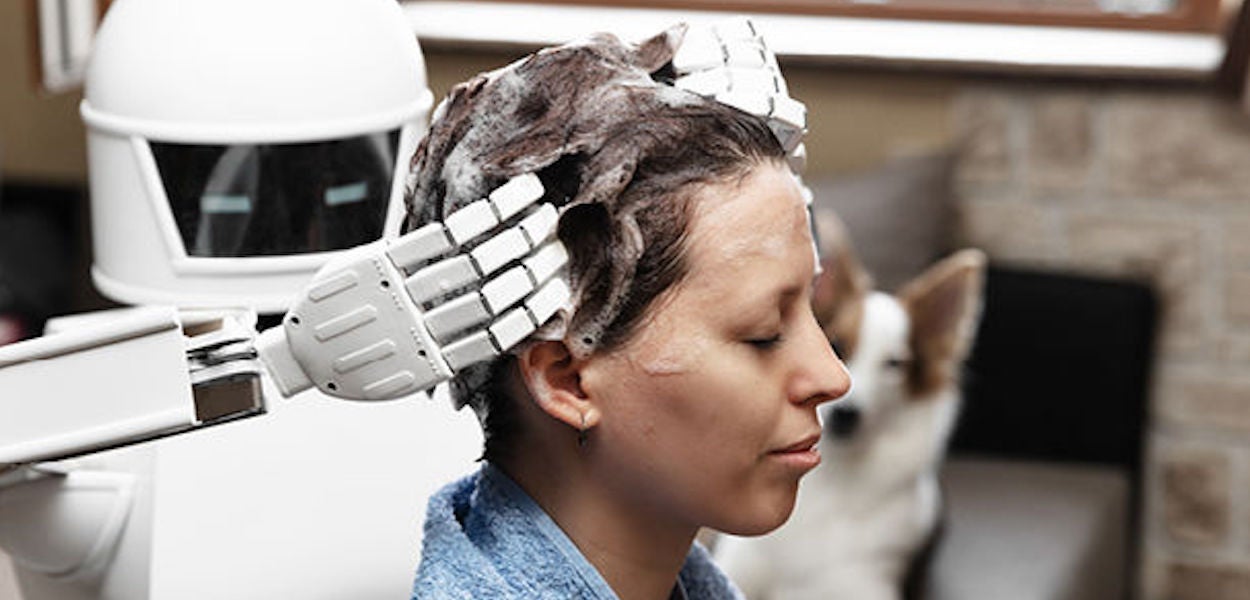 Robot washes hair from a human